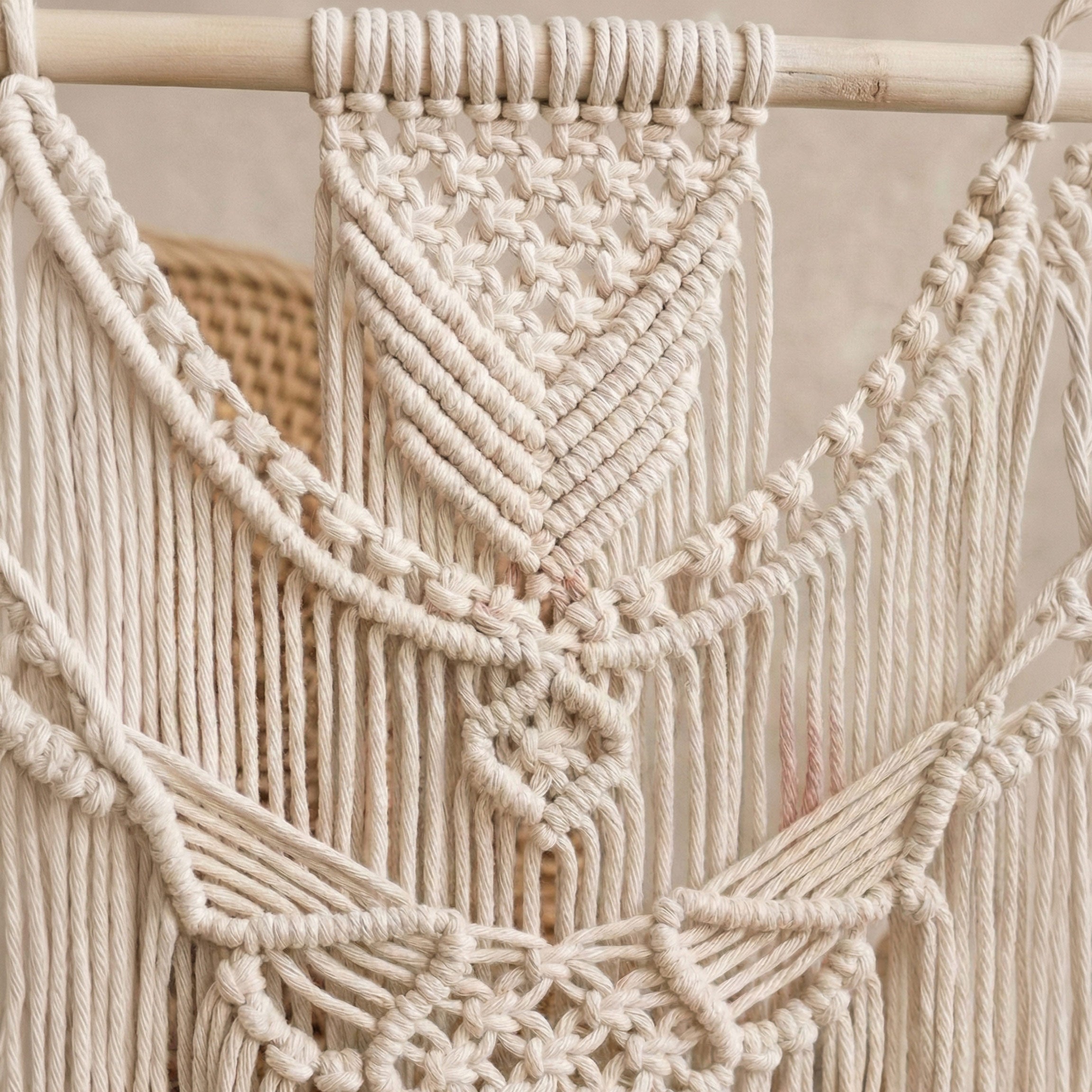 Close-up of intricate knots on a large boho macrame wall hanging made of recycled cotton