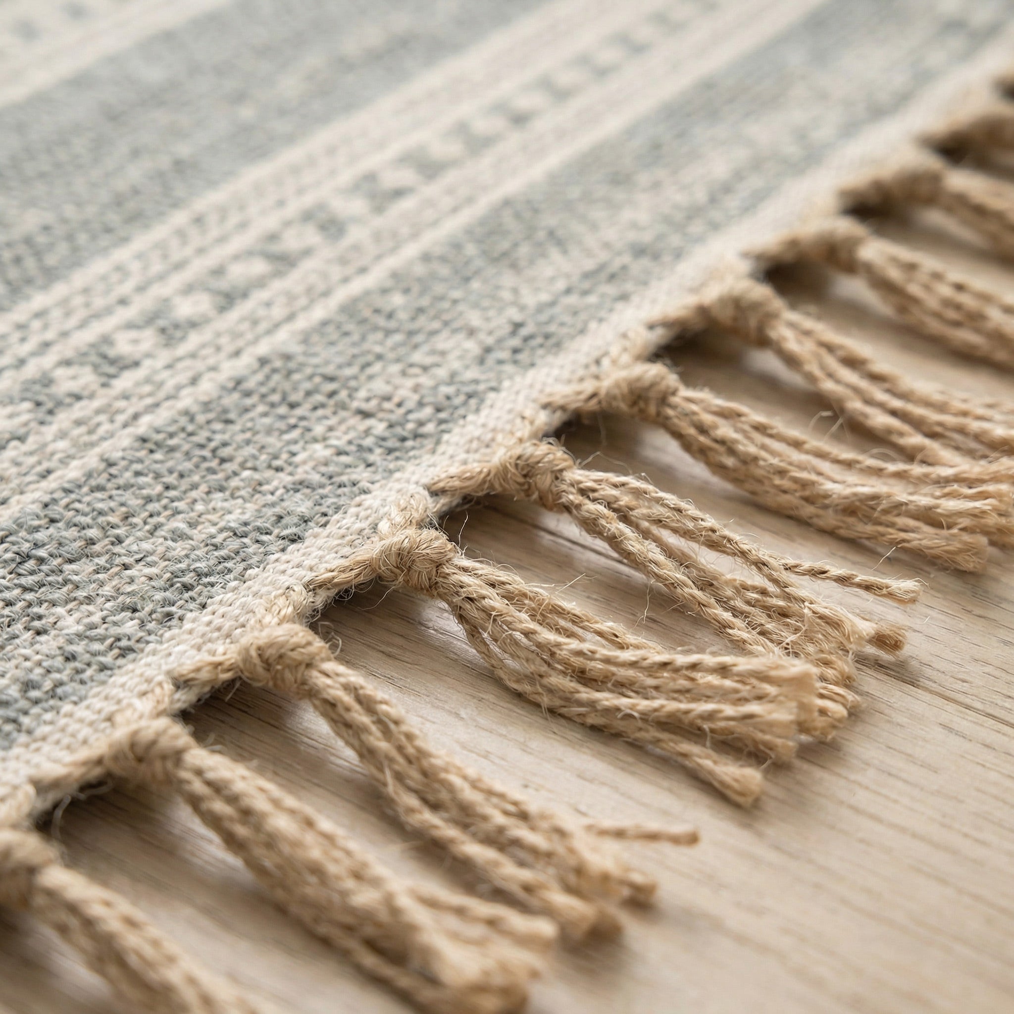 Close-up of handmade tassels and natural woven texture on an eco-friendly rug